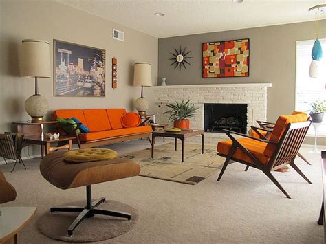 A mid century modern desk steals the spotlight. Inspiration for a mid-sized midcentury study room in Austin with white walls, medium hardwood floors, a freestanding desk, brown floor and exposed beam. This mid century modern home boasted irreplaceable features including original wood cabinets, wood ceiling, and a wall of floor to ceiling windows. 